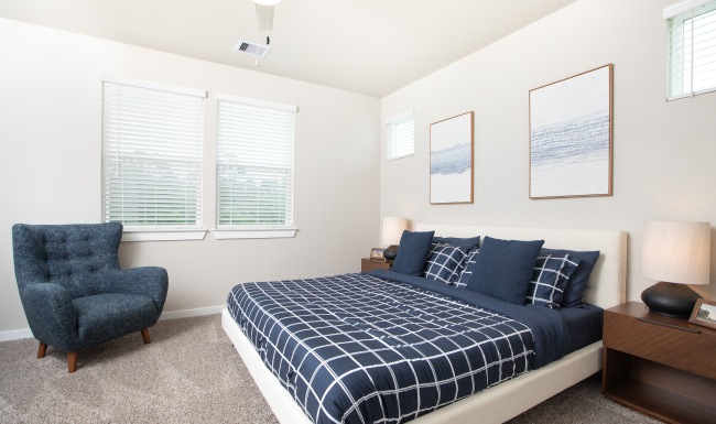 comfortable bed and chair in bedroom