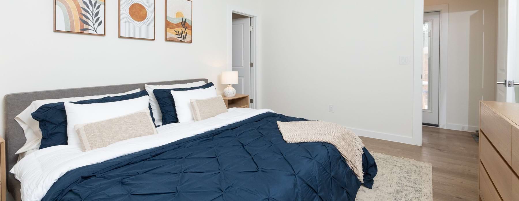 Bed with 3 photos hanging behind it