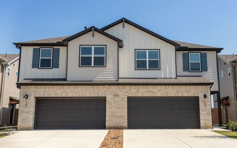 Street-level view of luxury townhomes in Spring, T