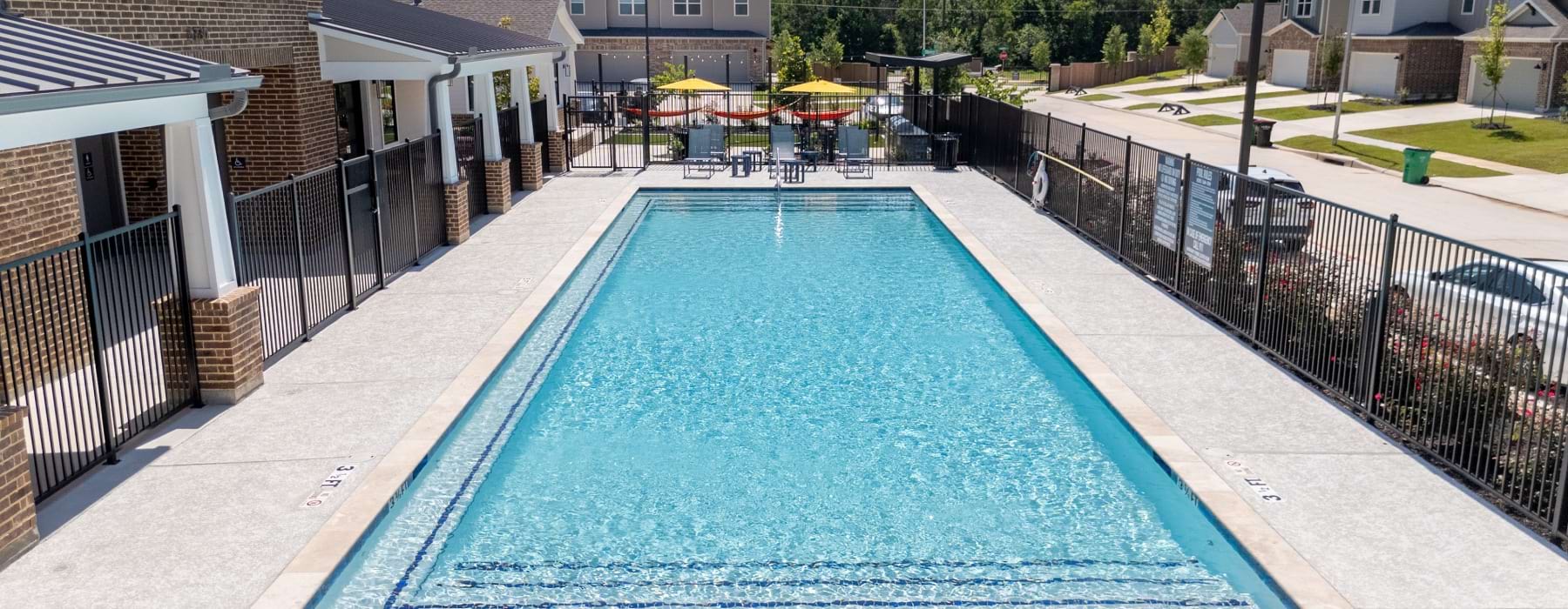 drone photo of the pool with table seating in the back